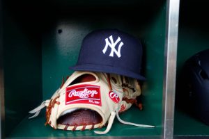 A New York Yankees hat and Rawlings baseball glove is seen during the MLB game against the Pittsburgh Pirates at PNC Park on April 21, 2017 in Pittsburgh, Pennsylvania.