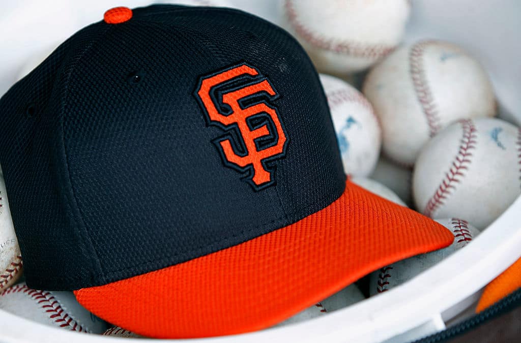 A San Francisco Giants hat sits in a bucket of baseballs during a Cactus League game between the Giants and the Milwaukee Brewers at Scottsdale Stadium on March 11, 2015 in Scottsdale, Arizona.