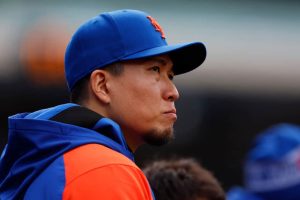 Kodai Senga #34 of the New York Mets watches from the dugout during the ninth inning of of game one of a double header against the Detroit Tigers at Citi Field on April 4, 2024 in New York City.
