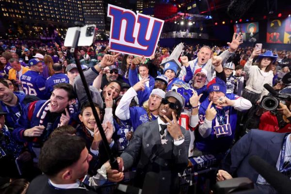 Malik Nabers celebrates with fans after being selected sixth overall by the New York Giants during the first round of the 2024 NFL Draft at Campus Martius Park and Hart Plaza on April 25, 2024 in Detroit, Michigan.