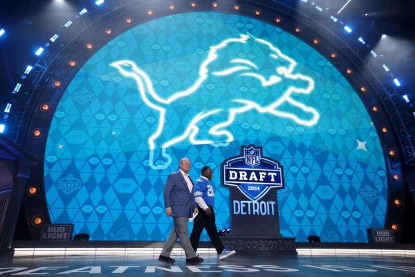Former Detroit Lions running back Barry Sanders and Detroit Mayor Mike Duggan take the stage during round two of the 2024 NFL draft at Campus Martius Park on April 26, 2024 in Detroit, Michigan.