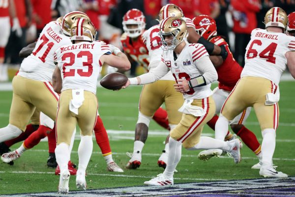 LAS VEGAS, NEVADA - FEBRUARY 11: Brock Purdy #13 of the San Francisco 49ers hands the ball to Christian McCaffrey #23 in the second quarter against the Kansas City Chiefs during Super Bowl LVIII at Allegiant Stadium on February 11, 2024 in Las Vegas, Nevada.