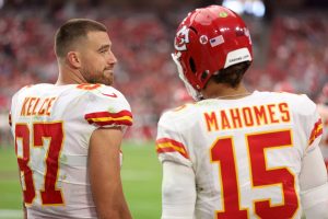 Tight end Travis Kelce #87 looks over at quarterback Patrick Mahomes #15 of the Kansas City Chiefs during the game against the Arizona Cardinals at State Farm Stadium on September 11, 2022 in Glendale, Arizona.