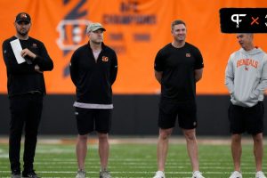 Director of college scouting Mike Potts (far left) and director of player personnel Duke Tobin (left) and head coach Zac Taylor (right) and defensive coordinator Lou Anarumo (far right) talk as rookie...