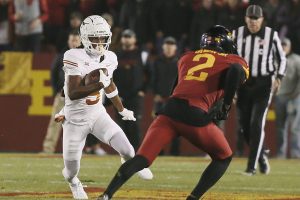 Texas Longhorns wide receiver Adonai Mitchell (5) runs with the ball as Iowa State Cyclones defensive back T.J. Tampa (2)attempts to tackle during the first quarter in the Big-12 football showdown at Jack Trice Stadium on Saturday, Nov. 18, 2023, in Ames, Iowa.