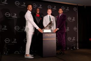 Heisman hopefuls (left to right) LSU Tigers quarterback Jayden Daniels and Ohio State Buckeyes wide receiver Marvin Harrison Jr. and Oregon Ducks quarterback Nix and Washington Huskies quarterback Michael Penix Jr. pose with the Heisman trophy during a press conference in the Astor ballroom at the New York Marriott Marquis before the presentation of the Heisman trophy.