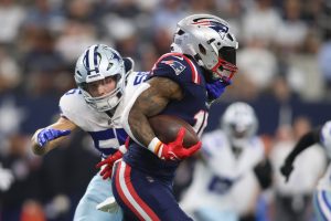 New England Patriots RB Ezekiel Elliott (15) runs with the ball against the Dallas Cowboys.
