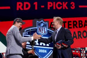 Drake Maye celebrates with NFL Commissioner Roger Goodell after being selected third overall by the New England Patriots during the first round of the 2024 NFL Draft at Campus Martius Park and Hart Plaza on April 25, 2024 in Detroit, Michigan.