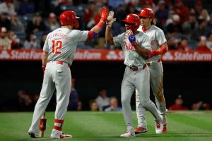 Johan Rojas #18 of the Philadelphia Phillies is congartulated by Kyle Schwarber #12 of the Philadelphia Phillies after hitting a two run home run against the Los Angeles Angels during the ninth inning at Angel Stadium of Anaheim on April 30, 2024 in Anaheim, California.