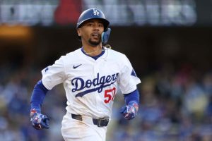 Mookie Betts #50 of the Los Angeles Dodgers runs to first base during the seventh inning against the St. Louis Cardinals at Dodger Stadium on March 31, 2024 in Los Angeles, California.