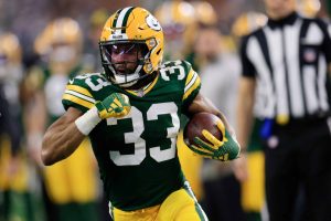 ARLINGTON, TEXAS - JANUARY 14: Aaron Jones #33 of the Green Bay Packers runs for yards against the Dallas Cowboys during the second quarter of the NFC Wild Card Playoff game at AT&T Stadium on January 14, 2024 in Arlington, Texas.