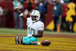 Wide receiver Tyreek Hill #10 of the Miami Dolphins celebrates after catching a first half touchdown pass agains the Washington Commanders at FedExField on December 03, 2023 in Landover, Maryland.