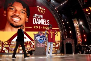 Jayden Daniels celebrates after being selected second overall by the Washington Commanders during the first round of the 2024 NFL Draft at Campus Martius Park and Hart Plaza on April 25, 2024 in Detroit, Michigan.