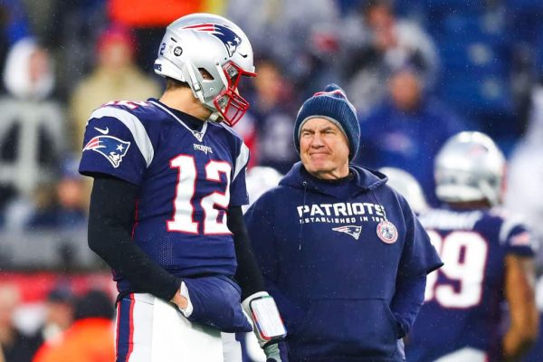 Tom Brady #12 talks to head coach Bill Belichick of the New England Patriots before a game against the Dallas Cowboys at Gillette Stadium on November 24, 2019 in Foxborough, Massachusetts.