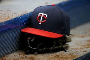 A Minnesota Twins hat and glove sit in the dugout during the game against the Milwaukee Brewers at Miller Park on April 21, 2016 in Milwaukee, Wisconsin.