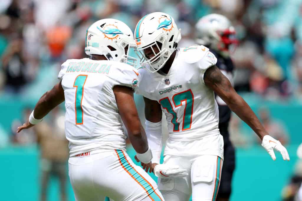 Quarterback Tua Tagovailoa #1 of the Miami Dolphins celebrates alongside Wide Receiver Jaylen Waddle #17 of the Miami Dolphins after scoring a touchdown in the second quarter of the game at Hard Rock Stadium on September 11, 2022 in Miami Gardens, Florida.