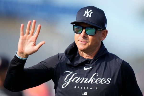 New York Yankees manager Aaron Boone waves to fans prior to a game against the Miami Marlins at Roger Dean Stadium on March 04, 2024 in Jupiter, Florida.