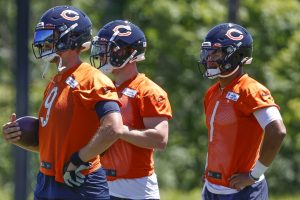 Chicago Bears quarterbacks Nick Foles, left, Andy Dalton, center, and Justin Fields, right, stand on the field during minicamp at Halas Hall. Mandatory Credit: Kamil Krzaczynski-USA TODAY Sports