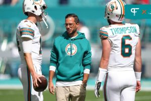 Miami Dolphins head coach Mike McDaniel talks with quarterbacks Skylar Thompson (6) and Mike White (14).