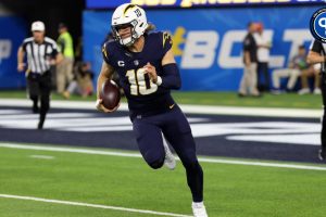 Los Angeles Chargers quarterback Justin Herbert (10) runs with a ball during the first quarter against the Baltimore Ravens at SoFi Stadium.