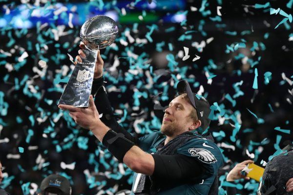 Philadelphia Eagles quarterback Nick Foles (9) hoist the Vince Lombardi Trophy after a victory against the New England Patriots in Super Bowl LII at U.S. Bank Stadium.