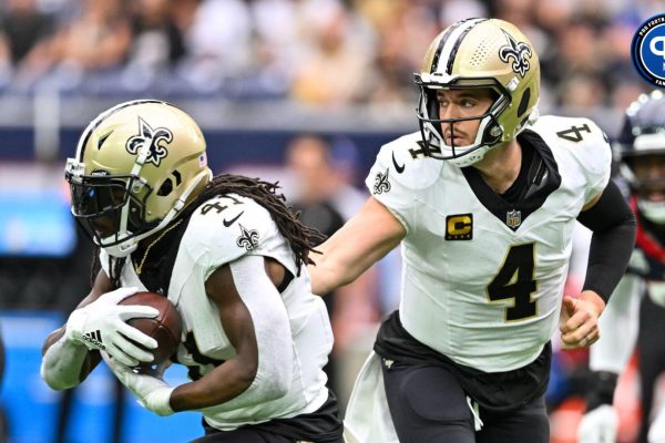 New Orleans Saints quarterback Derek Carr (4) hands off the ball to running back Alvin Kamara (41) during the first quarter against the Houston Texans at NRG Stadium.