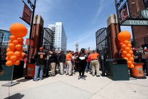 Fans enter the stadium before the start of the Baltimore Orioles and Milwaukee Brewers game during Opening Day at Oriole Park at Camden Yards on April 11, 2022 in Baltimore, Maryland.