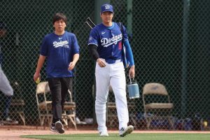 Shohei Ohtani #17 of the Los Angeles Dodgers and interpreter Ippei Mizuhara arrive to a game against the Chicago White Sox at Camelback Ranch on February 27, 2024 in Glendale, Arizona.