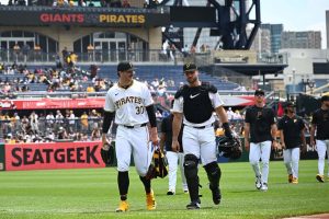 Paul Skenes #30 of the Pittsburgh Pirates talks with Joey Bart #14 as they walk in from the bullpen before the start off the game against the San Francisco Giants at PNC Park on May 23, 2024 in Pittsburgh, Pennsylvania.