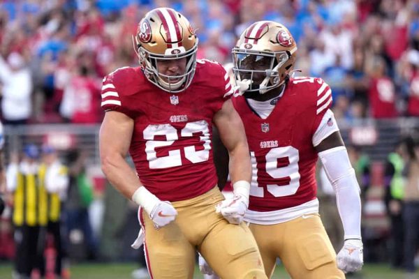 Christian McCaffrey #23 of the San Francisco 49ers celebrates with teammates after scoring a touchdown during the second quarter against the Detroit Lions in the NFC Championship Game at Levi