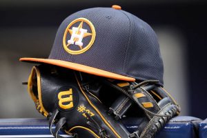 Jose Altuve #27 of Houston Astros rests his hat and glove in the dugout before the game against the Milwaukee Brewers at Miller Park on April 10, 2016 in Milwaukee, Wisconsin.