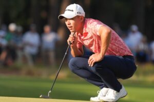 Collin Morikawa bunker shot slides by hole, rolls off green