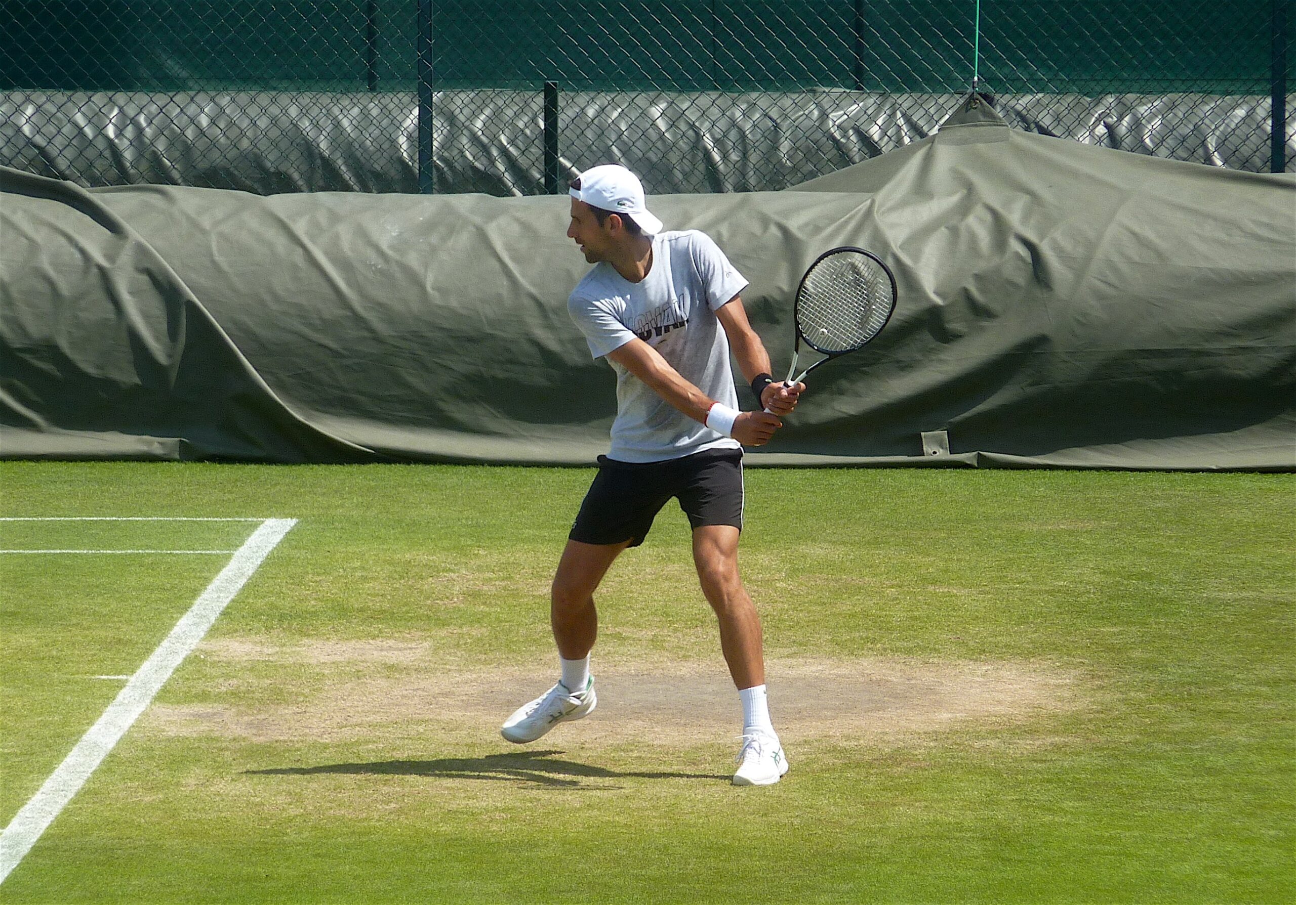 Djokovic practicing at Wimbledon, not ruling out participation