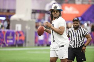 LAS VEGAS, NEVADA - FEBRUARY 09: Former NFL quarterback Cam Newton attempts a pass during a celebrity flag football game at the Mandalay Bay Convention Center on February 09, 2024 in Las Vegas, Nevada.