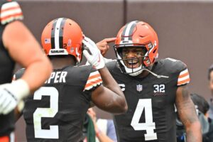 Deshaun Watson #4 of the Cleveland Browns is congratulated by Amari Cooper #2 after scoring a rushing touchdown against the Cincinnati Bengals during the first half at Cleveland Browns Stadium on September 10, 2023 in Cleveland, Ohio.
