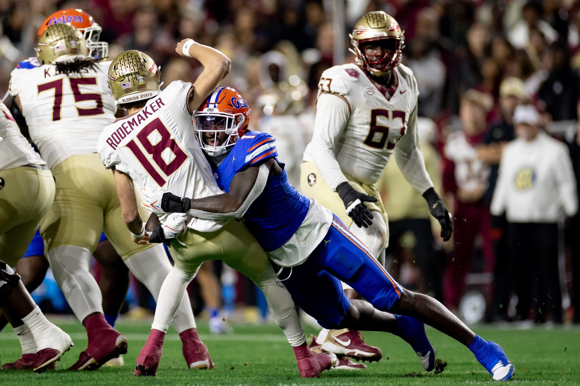Florida Gators DE Princely Umanmielen (1) tackles Florida State Seminoles QB Tate Rodemaker (18).