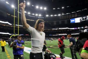 Trevor Lawrence #16 of the Jacksonville Jaguars celebrates as he leaves the field after defeating the New Orleans Saints 31-24 at Caesars Superdome on October 19, 2023 in New Orleans, Louisiana.