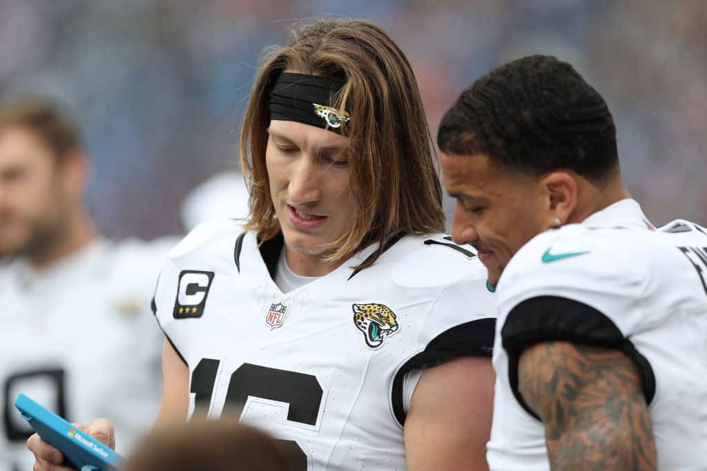 Trevor Lawrence #16 of the Jacksonville Jaguars reviews a play on the sideline during the first half against the Tennessee Titans at Nissan Stadium on January 07, 2024 in Nashville, Tennessee.