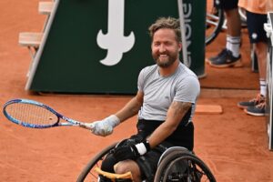 Rob Shaw smiles during his wheelchair singles match at the French Open. He will be competing at the Paralympics in July.