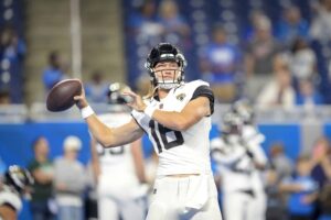 Trevor Lawrence #16 of the Jacksonville Jaguars passes the ball during the warmups before the preseason game against the Detroit Lions at Ford Field on August 19, 2023 in Detroit, Michigan.