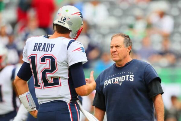 New England Patriots head coach Bill Belichick talks with New England Patriots quarterback Tom Brady (12) on the field prior to the National Football League game between the New York Jets and the New England Patriots on October 15, 2017, at MetLife Stadium in East Rutherford, NJ.