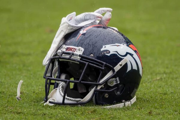 The helmet and gloves of Will Parks #34 of the Denver Broncos · rests on the field before the game between the Baltimore Ravens and the Denver Broncos at M&T Bank Stadium on September 23, 2018 in Baltimore, Maryland.
