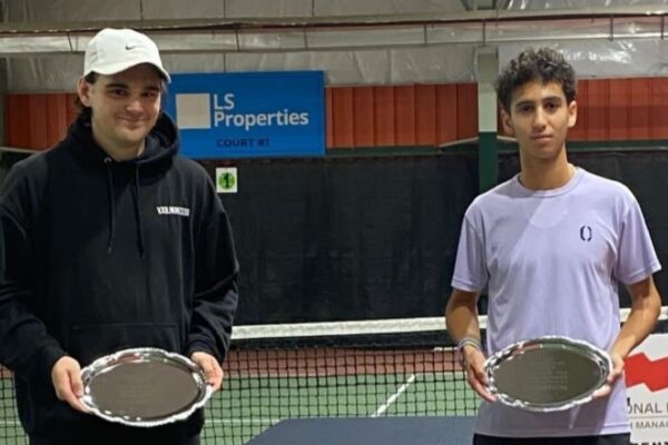 Two Canadians who won ITF Junior titles in Winnipeg hold up their trophies. Canadians also swept the titles in Kamloops.