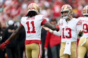 Brock Purdy #13 of the San Francisco 49ers celebrates a touchdown with Brandon Aiyuk #11 of the San Francisco 49ers during the first quarter at EverBank Stadium on November 12, 2023 in Jacksonville, Florida.