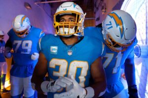 Trey Pipkins III #79, Austin Ekeler #30 and Jordan McFadden #71 of the Los Angeles Charger prepare in the tunnel before a game against the Kansas City Chiefs at SoFi Stadium on January 07, 2024 in Inglewood, California.