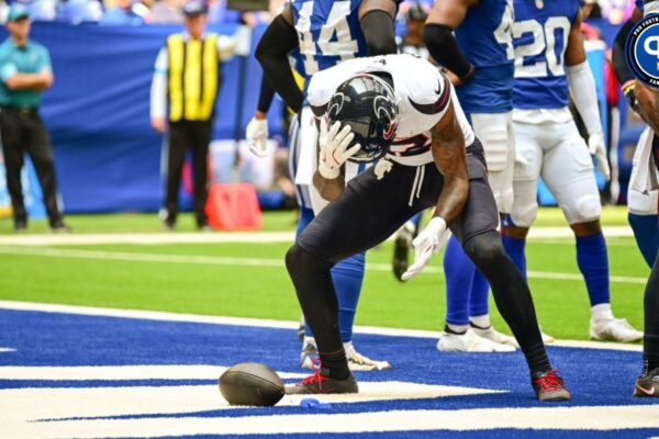 Houston Texans wide receiver Nico Collins (12) stands over the ball and his mouthguard after a touchdown during the second quarter against the Indianapolis Colts at Lucas Oil Stadium.