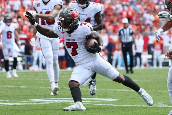 Sep 22, 2024; Tampa, Florida, USA; Tampa Bay Buccaneers running back Bucky Irving (7) runs with the ball against the Denver Broncos during the first half at Raymond James Stadium. Mandatory Credit: Kim Klement Neitzel-Imagn Images