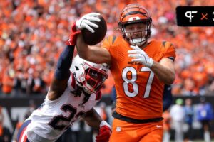 Cincinnati Bengals tight end Tanner Hudson (87) runs to the end zone, but eventually fumbles the ball as New England Patriots safety Kyle Dugger (23) causes the turnover during the second quarter at Paycor Stadium. Mandatory Credit: Joseph Maiorana-Imagn Images