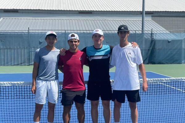 The four U18 boys doubles finalists pose at the the net at the U18 Fischer Outdoor Nationals, one of four Canadian junior championships over the last month.