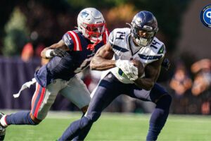 Sep 15, 2024; Foxborough, Massachusetts, USA; Seattle Seahawks wide receiver DK Metcalf (14) runs the ball against New England Patriots cornerback Christian Gonzalez (0) in the second half at Gillette Stadium. Mandatory Credit: David Butler II-Imagn Images